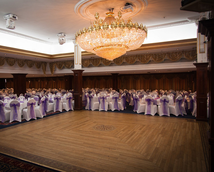A grand ballroom set up for a wedding reception at one of the popular wedding venues.