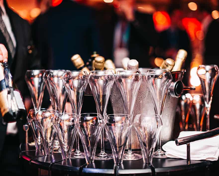 Corporate event with champagne glasses on a table.