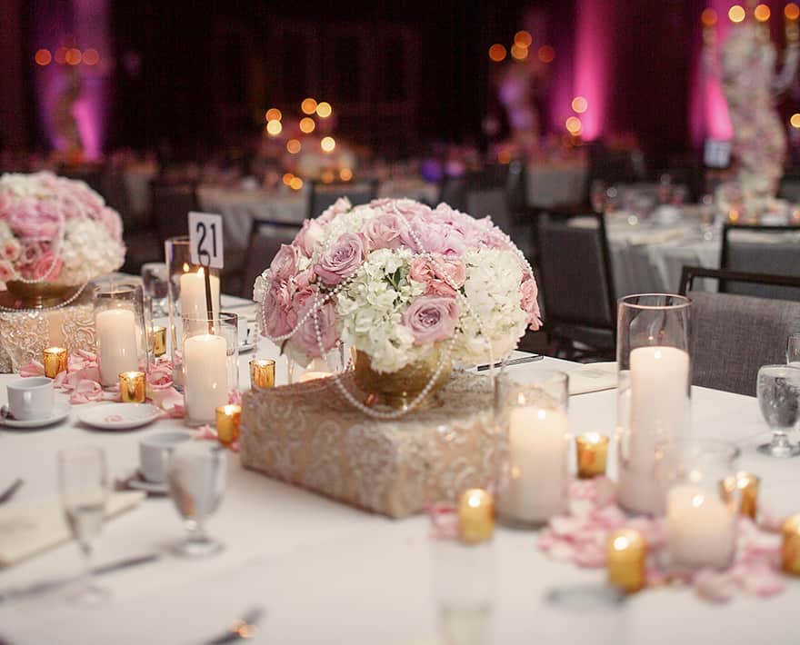 A table with candles and flowers on it at the East Midlands Conference Centre.