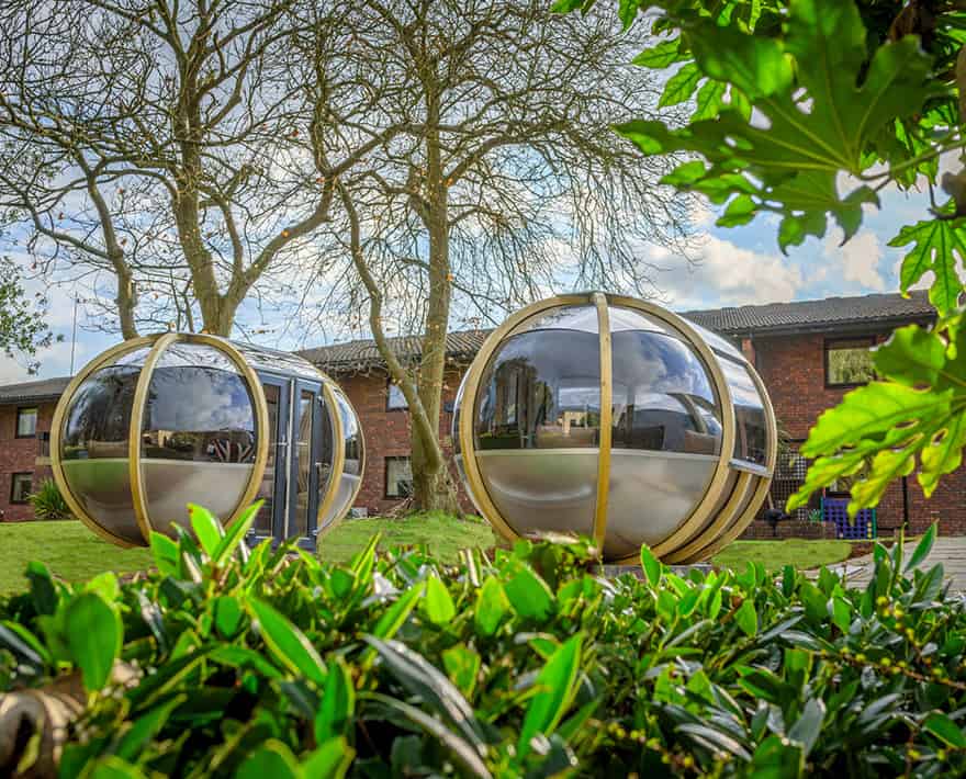 Two silver spheres in front of a building.